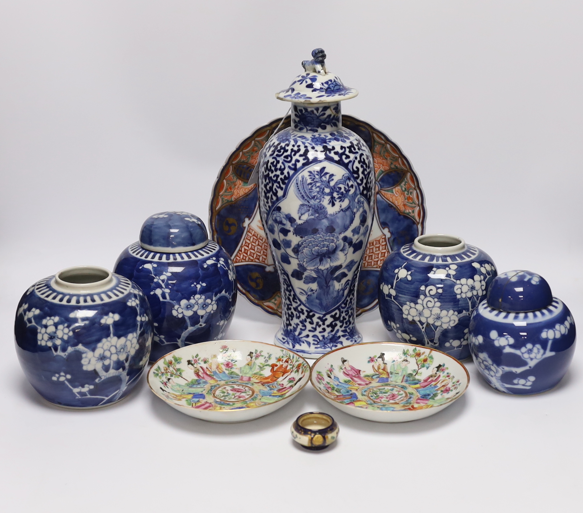 An early 20th century Chinese blue and white vase and cover, pair of 19th century Chinese famille rose dishes, four prunus jars, two covers, a Japanese Meiji period Imari dish and a small satsuma pot, some damage, talles